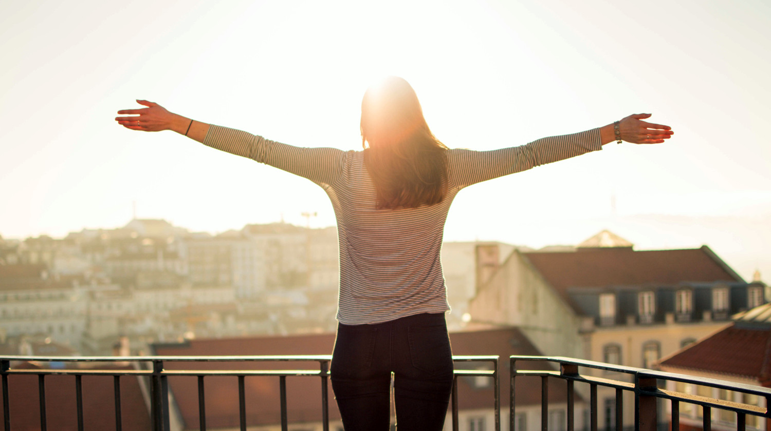 Feature | Balcony person standing sunshine | Morning Routine Hacks That Will Make Life Easier